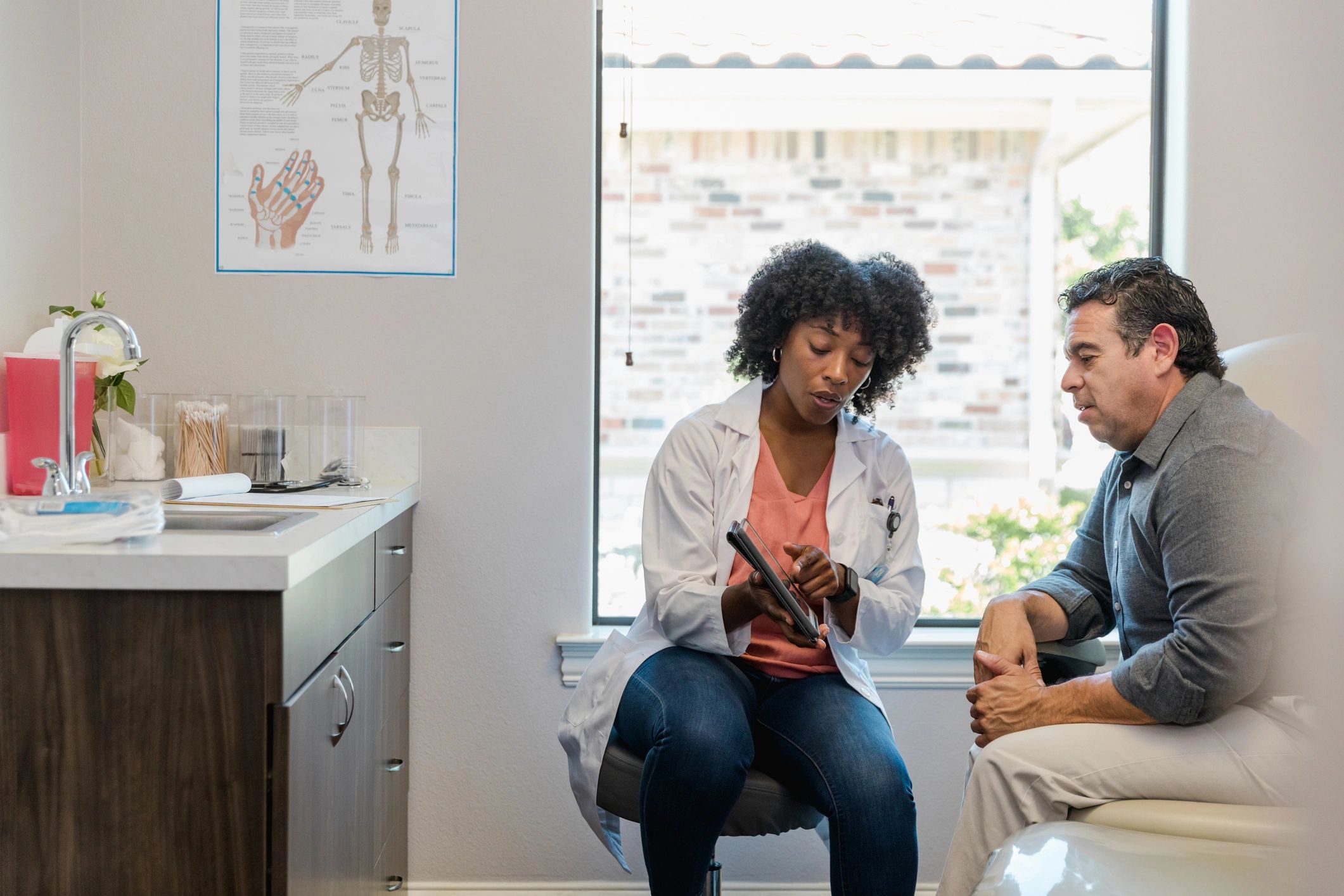 Doctor and patient reviewing information together on a tablet