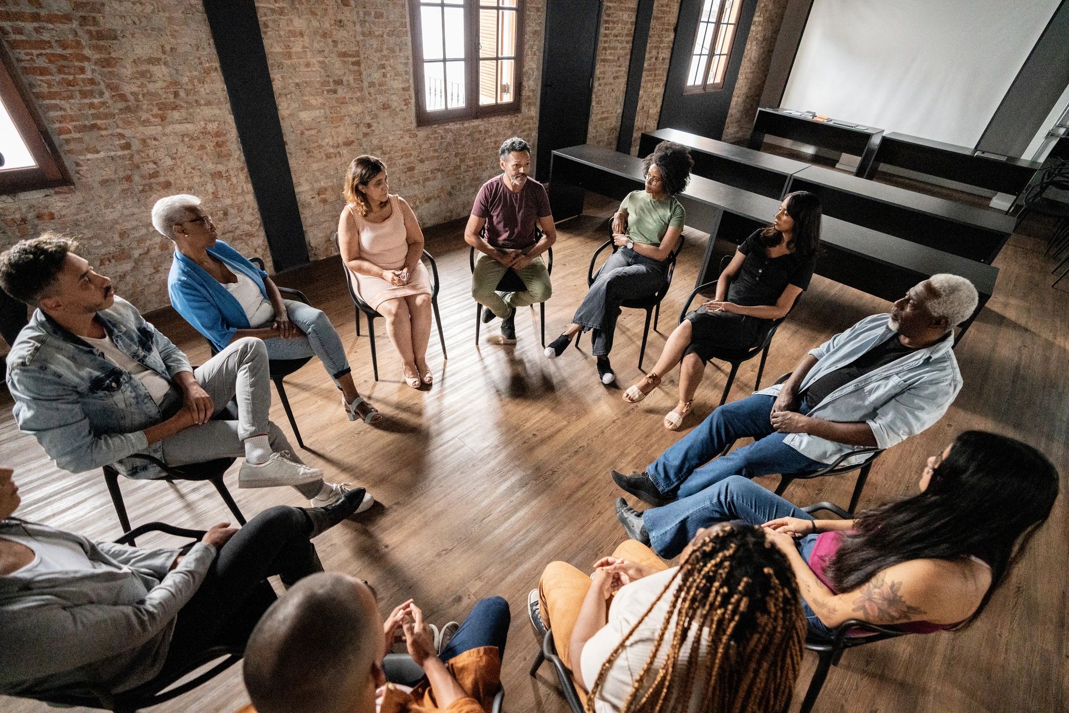 People seated in a circle during a support group discussion