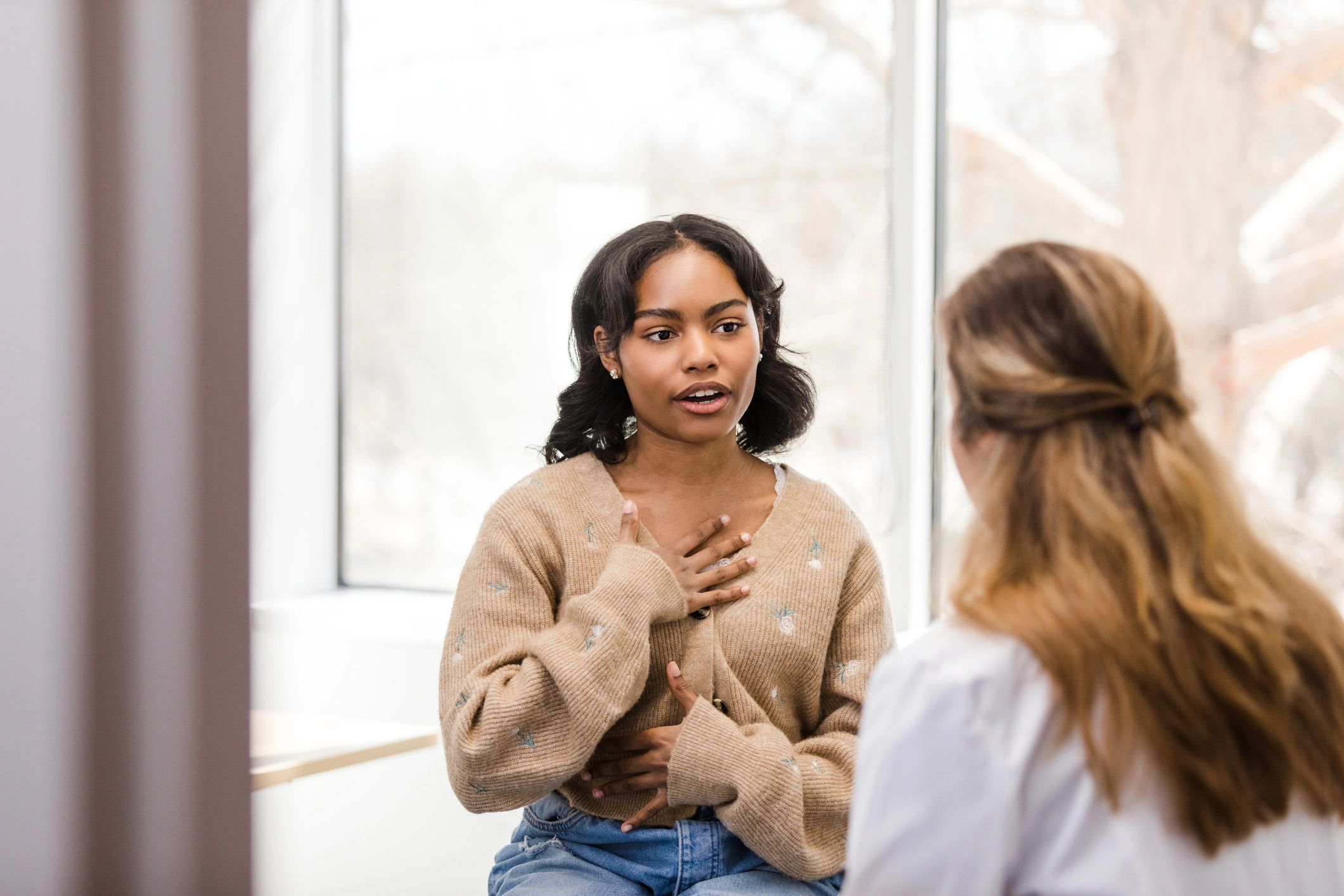 Patient describing symptoms while speaking with a clinician
