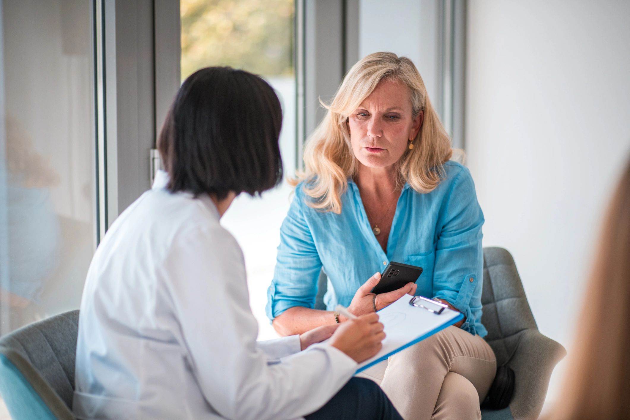 Doctor speaking with a patient in a clinic setting