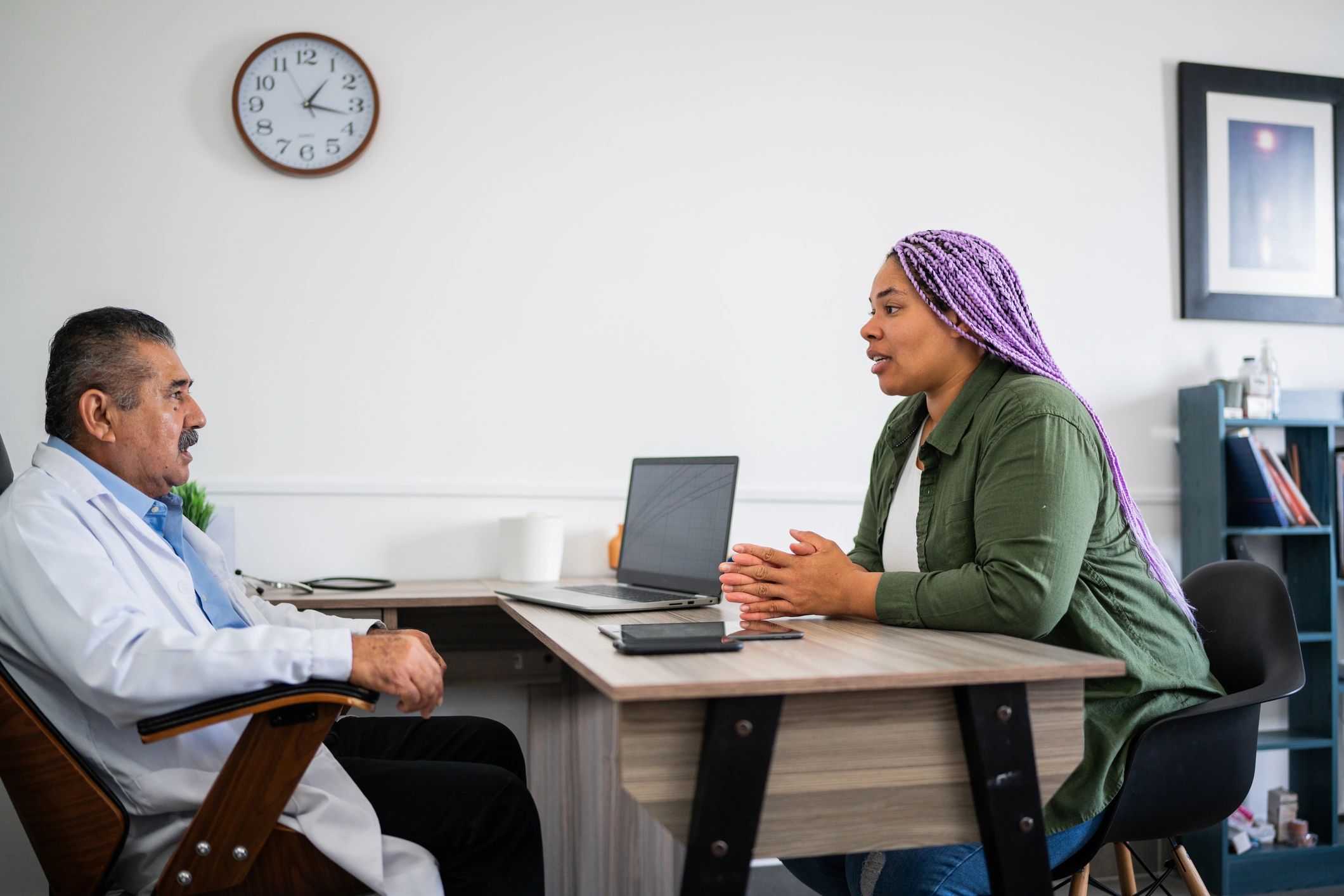 Patient speaking with a doctor during a consultation